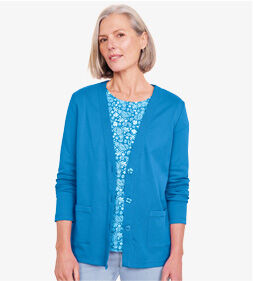 model wearing blue cardigan over patterned top