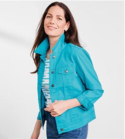 model smiling while wearing a blue DreamFlex Colored Jean Jacket