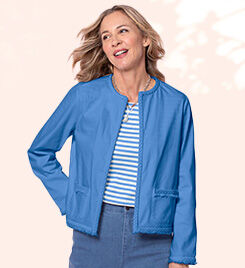 model wearing blue jacket and striped shirt over blue jeans