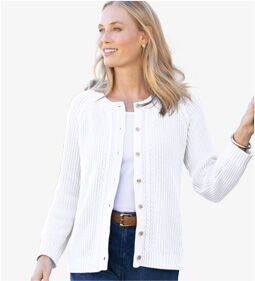 woman wearing white cardigan over a white shirt smiling to the left