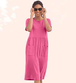 model wearing a pink dress and dark sunglasses