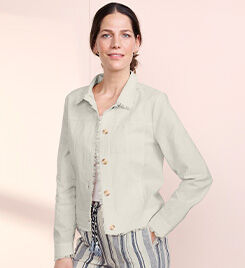 model wearing beige jacket and striped pants