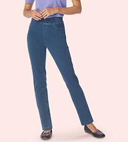 model wearing slim blue jeans and dark slippers with a purple top