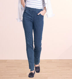 lower half of person walking and wearing dark blue pants