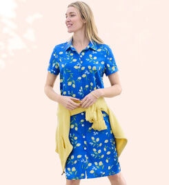 model wearing a blue and white patterned dress with yellow sweater tied around the waist