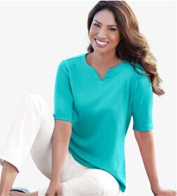 woman wearing green shirt and white pants