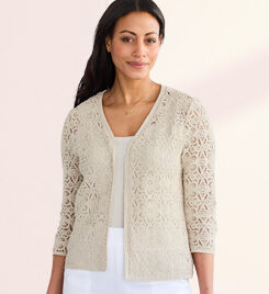 model wearing light tan cardigan and white pants