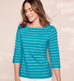 model wearing a teal and white striped top and white pants