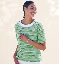 model wearing a green and white striped top and white pants