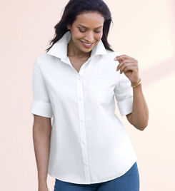 smiling model wearing a white shirt and blue pants