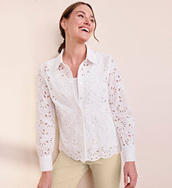 smiling model wearing a white shirt and light yellow pants