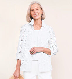 smiling model wearing a white shirt, top and pants