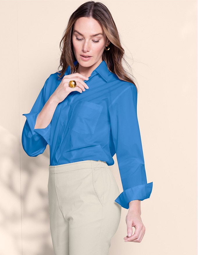 model wearing blue foxcroft shirt and beige pants