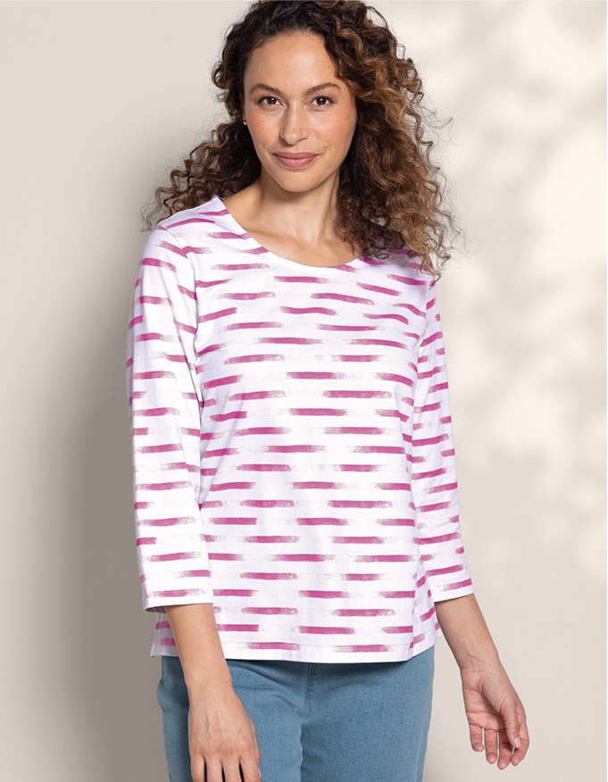 model wearing stripe patterned top with blue pants