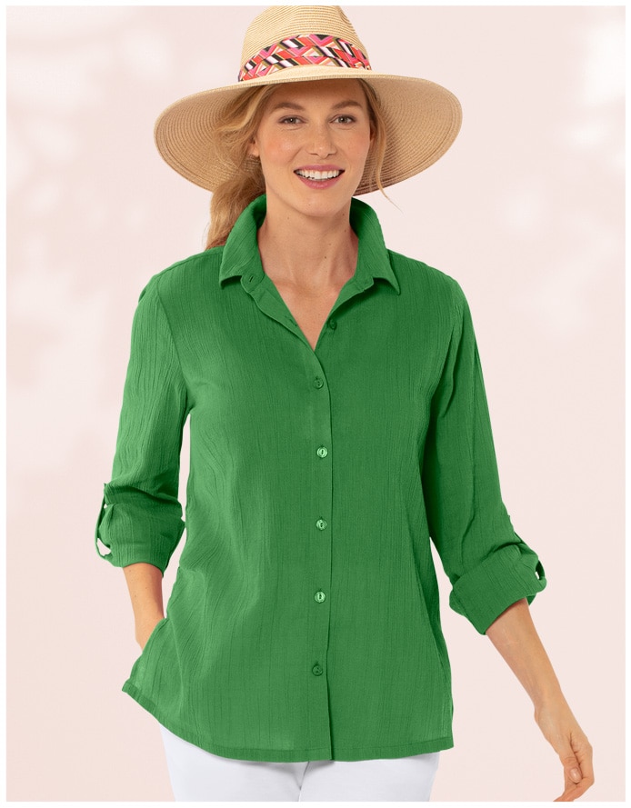model wearing green crinkle shirt and white pants